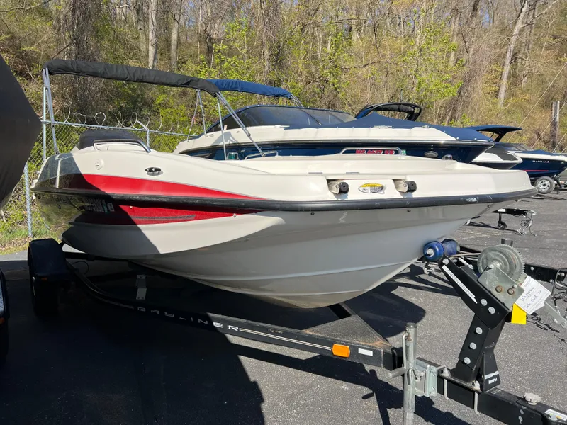 Slide: The Image of 2011 Bayliner 197 boat on a trailer in a parking lot. - 18