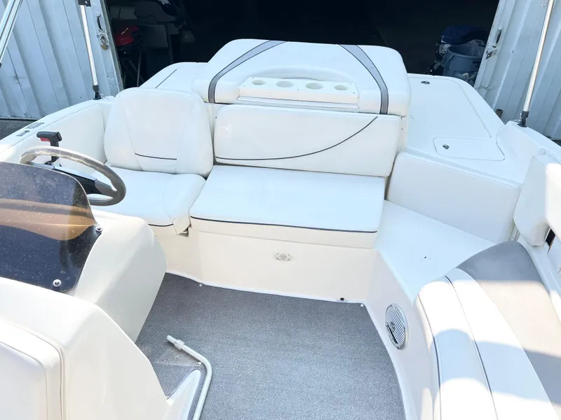 Slide: The Image of 2011 Bayliner 197 boat interior with white seating and steering wheel. - 3