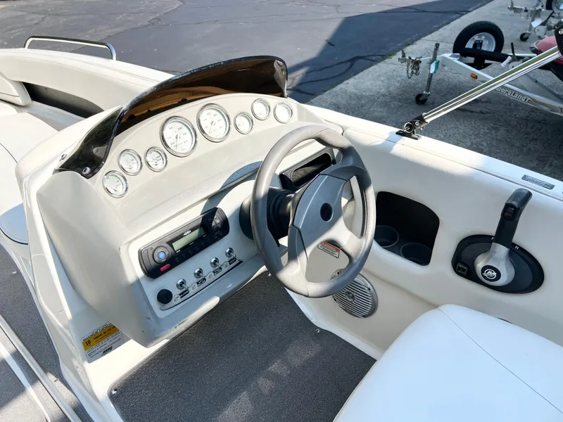 Slide: The Image of 2011 Bayliner 197 boat dashboard with steering wheel and control panel. - 4