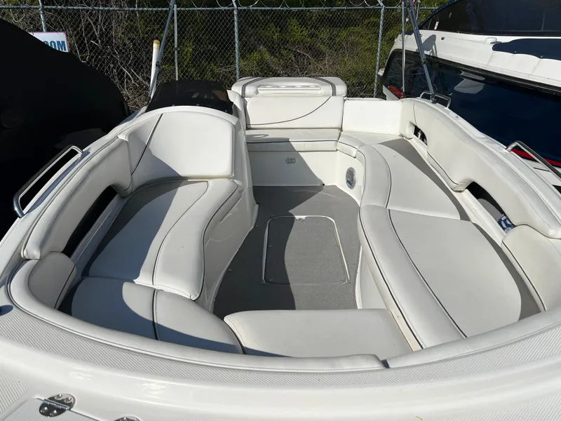 Slide: The Image of 2011 Bayliner 197 boat interior with white seating and grey flooring. - 7