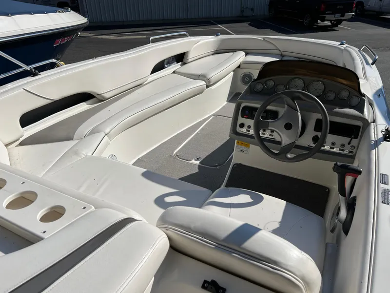 Slide: The Image of 2011 Bayliner 197 boat interior with white seating and control panel. - 8