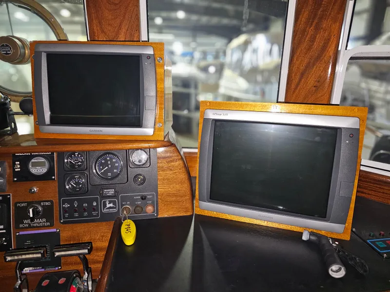 Slide: The Image of Florida Bay Coaster 42, 1999 model, green hull, docked indoors among other boats. - 12