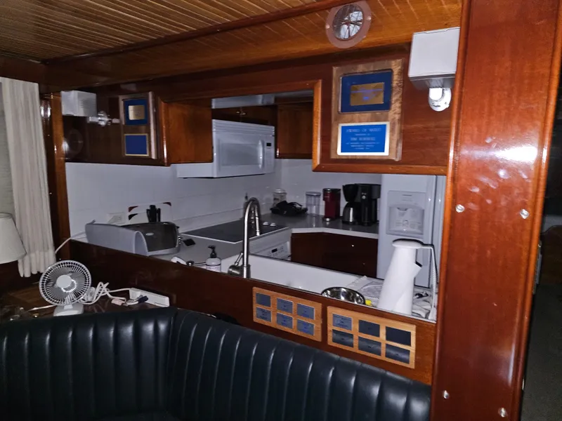 Slide: The Image of Interior of 1999 Florida Bay Coaster 42 boat with wooden dashboard and navigation equipment. - 14