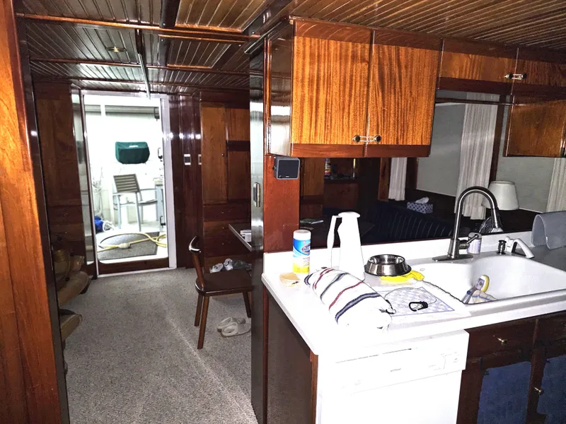 Slide: The Image of 1999 Florida Bay 42 Coaster boat dashboard with navigation screens and control panel. - 16