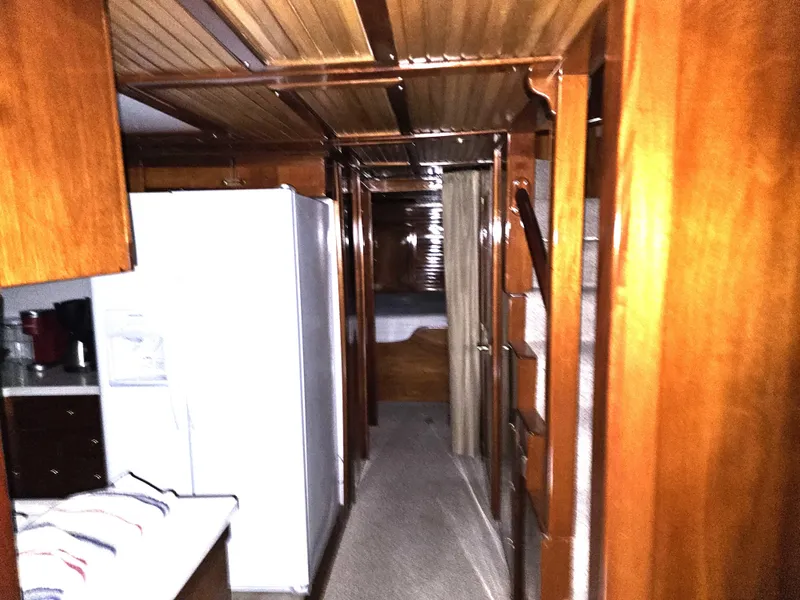 Slide: The Image of Interior of 1999 Florida Bay 42 Coaster boat with wooden cabinetry and navigation equipment. - 17