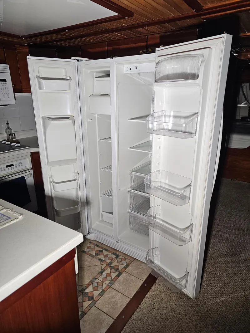 Slide: The Image of Interior of 1999 Florida Bay Coaster 42 boat with control panel and captain's chair. - 19