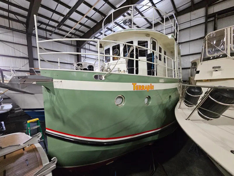 Slide: The Image of 1999 Florida Bay 42 Coaster boat in a warehouse, named Terrapin. - 2