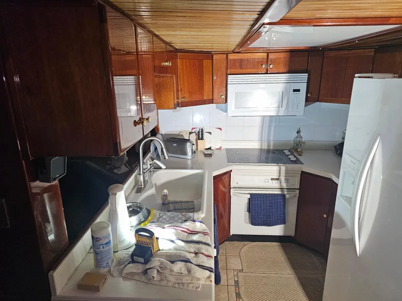 Slide: The Image of Interior of 1999 Florida Bay 42 Coaster yacht with kitchen and seating area. - 21