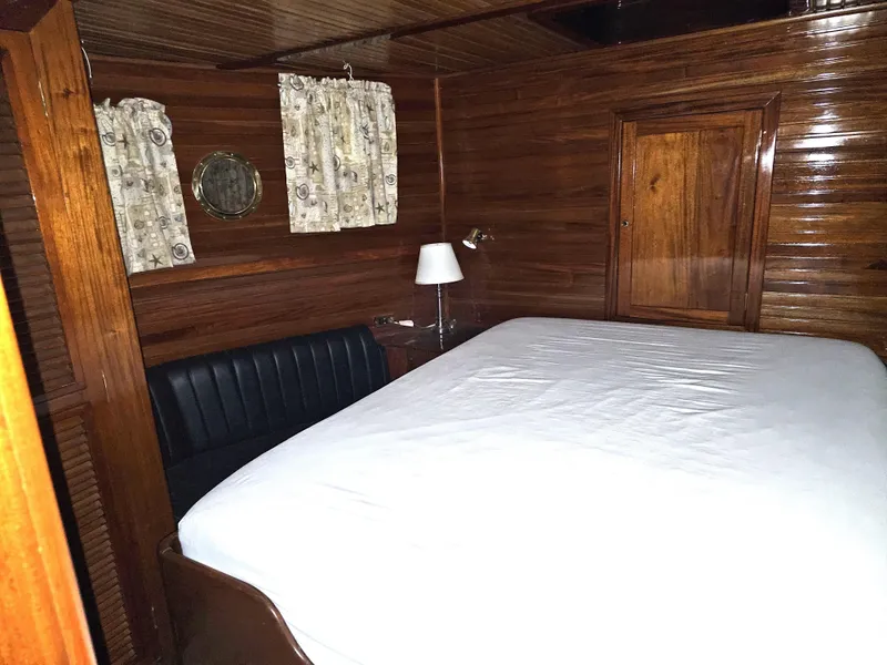 Slide: The Image of Interior of 1999 Florida Bay 42 Coaster boat with wooden finishes and kitchen area. - 24