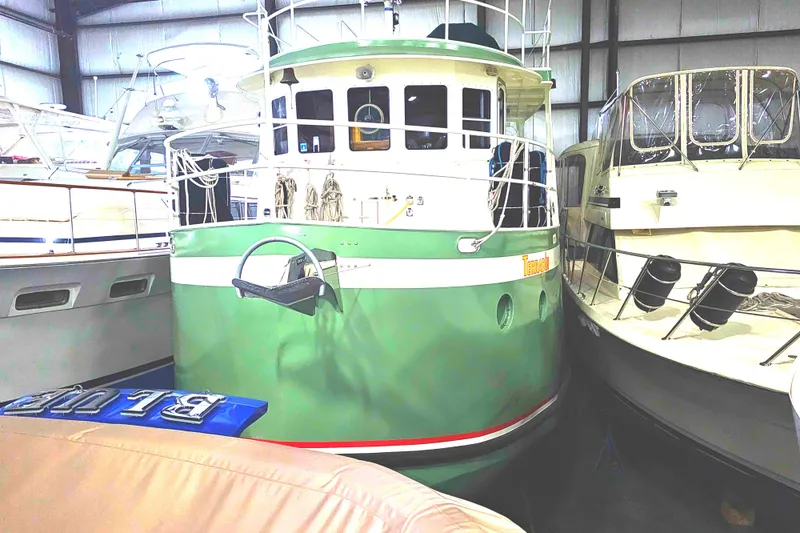 Slide: The Image of 1999 Florida Bay 42 Coaster boat in a warehouse for maintenance. - 4