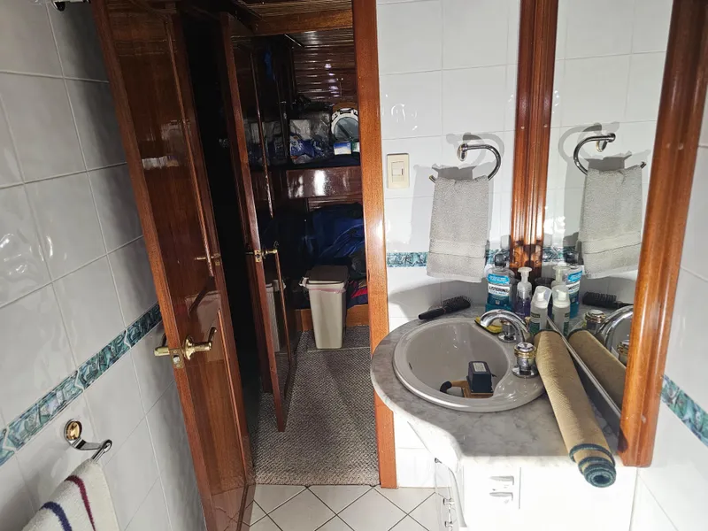 Slide: The Image of Storage area in a 1999 Florida Bay Coaster 42 boat with various items and supplies. - 41