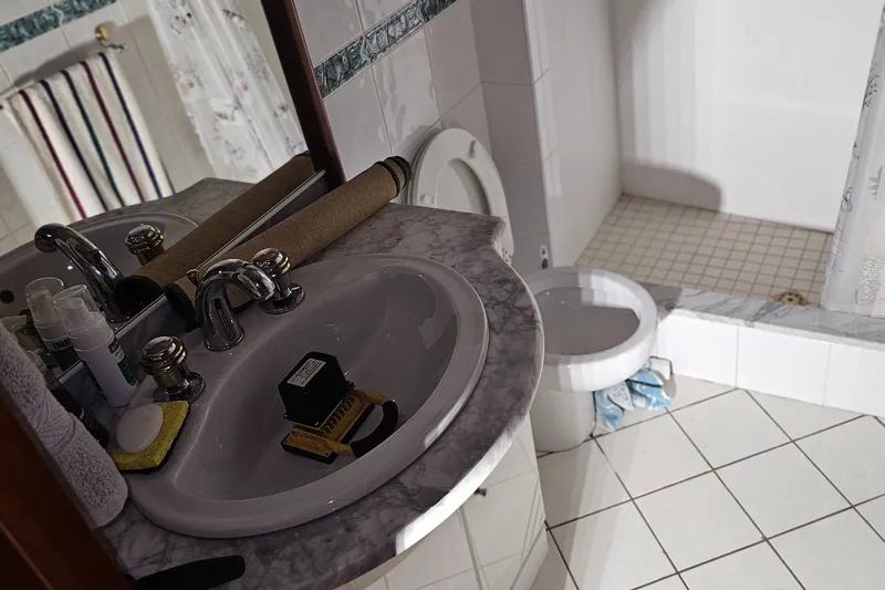 Slide: The Image of Bathroom interior of 1999 Florida Bay Coaster 42 with marble sink and shower curtain. - 44