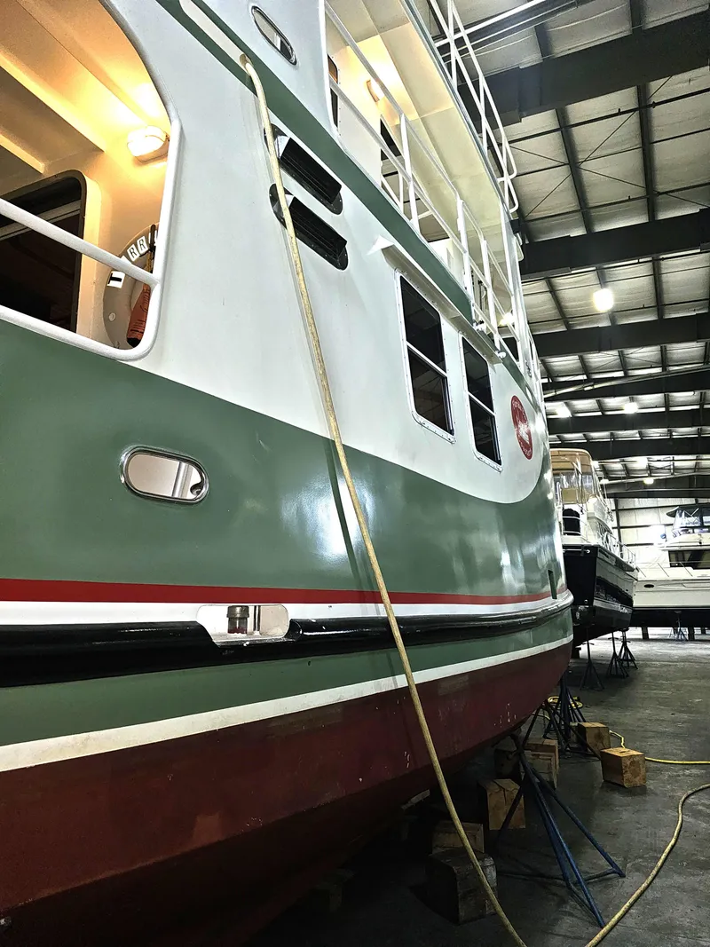 Slide: The Image of 1999 Florida Bay 42 Coaster boat in storage, green hull, named Terrapin. - 6