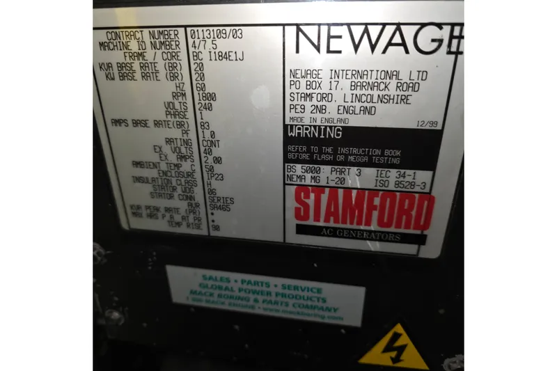 Slide: The Image of Label on Newage Stamford AC generator, detailing specifications and warnings, made in England, December 1999. - 60