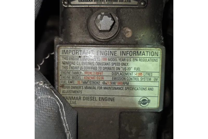 Slide: The Image of 1999 Florida Bay Coaster 42 engine information label, Yanmar diesel specifications. - 61