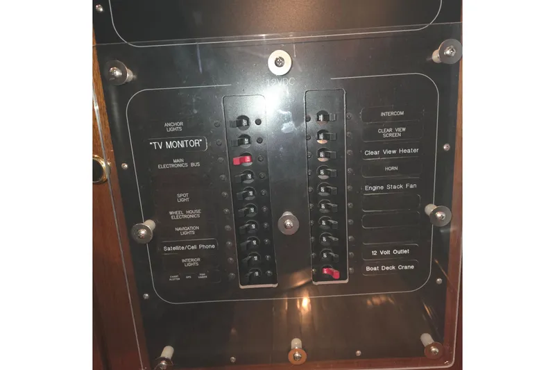 Slide: The Image of Control panel of a 1999 Florida Bay Coaster 42 boat, featuring various switches and labels. - 62