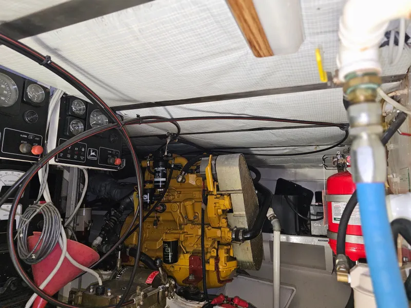 Slide: The Image of Engine room of 1999 Florida Bay Coaster 42 with gauges and fire extinguisher. - 67