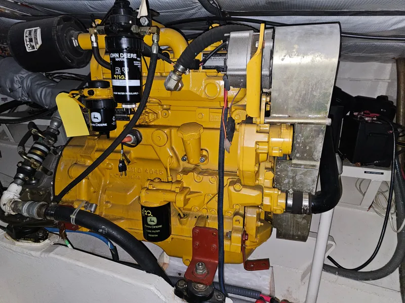 Slide: The Image of 1999 Florida Bay 42 Coaster engine compartment with John Deere engine. - 69