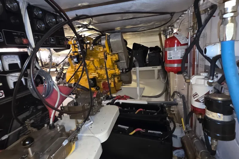 Slide: The Image of Engine room of a 1999 Florida Bay Coaster 42 with visible machinery and equipment. - 71