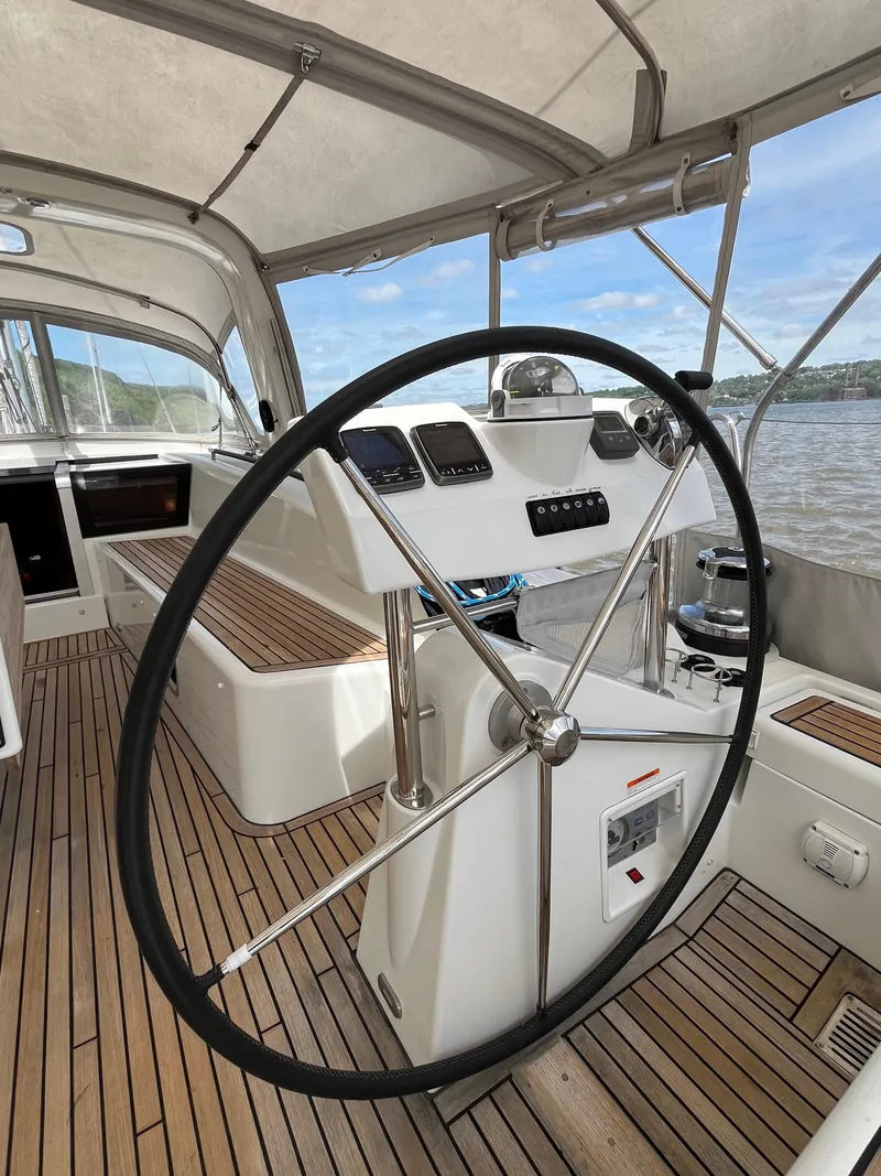 Slide: The Image of Steering wheel of 2012 Beneteau Oceanis 58 yacht with wooden deck and canopy. - 10
