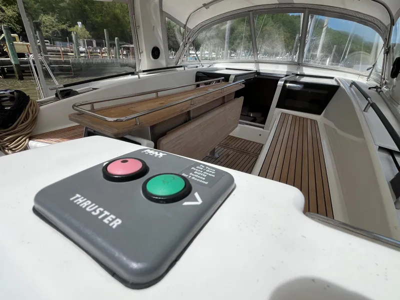 Slide: The Image of Beneteau Oceanis 58 yacht cockpit with thruster controls, 2012 model, featuring teak decking. - 12