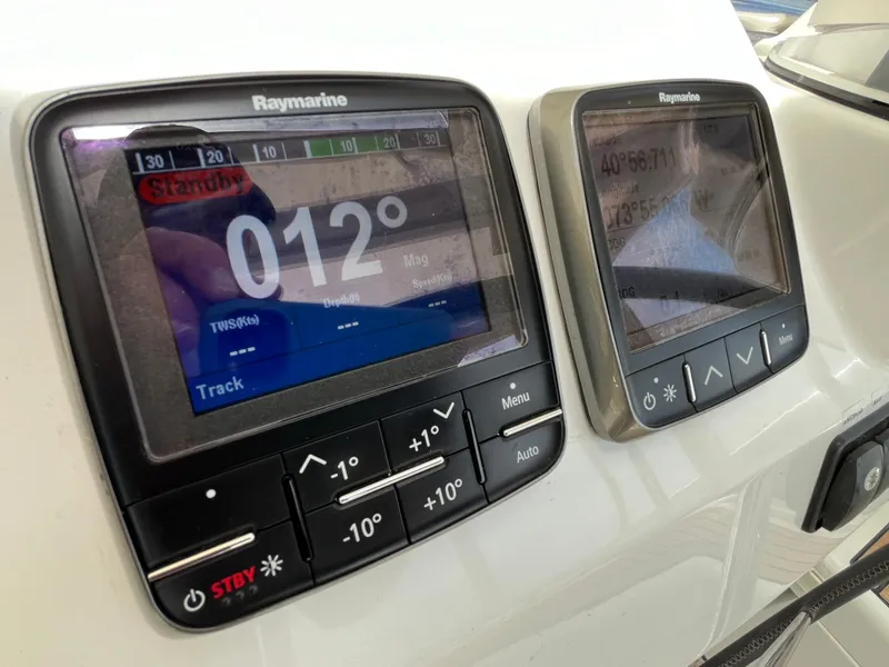 Slide: The Image of Raymarine navigation displays on 2012 Beneteau Oceanis 58 yacht, showing heading and coordinates. - 13