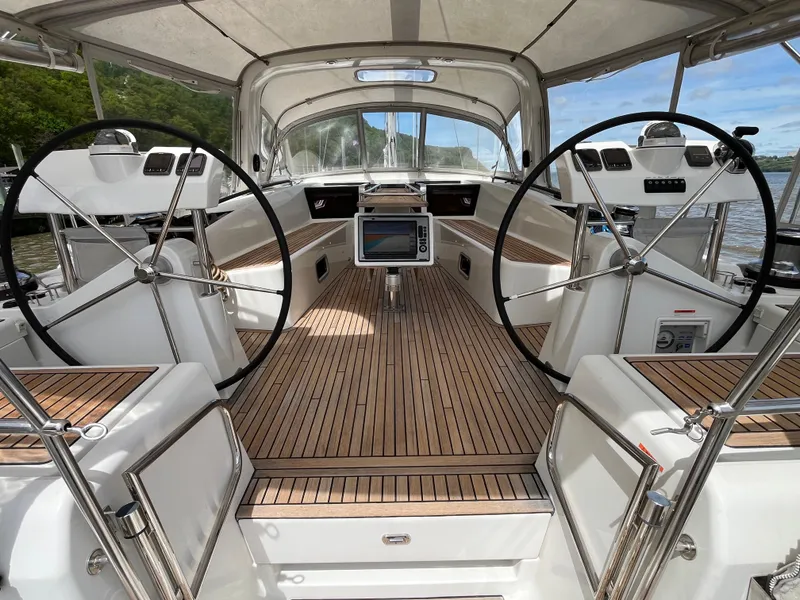 Slide: The Image of 2012 Beneteau Oceanis 58 yacht cockpit with dual steering wheels and teak decking. - 19