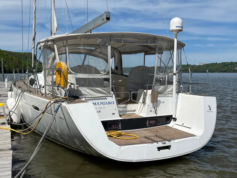 Slide: The Image of 2012 Beneteau Oceanis 58 yacht docked, featuring spacious deck and modern design. - 2