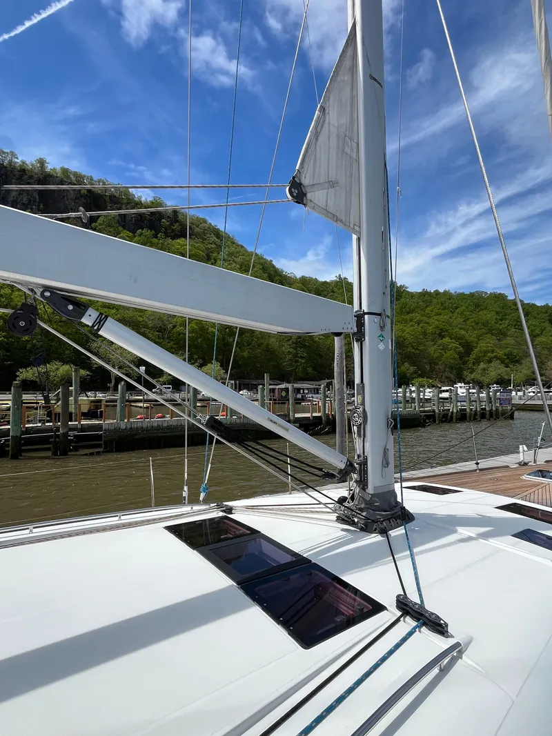 Slide: The Image of Sailing yacht Beneteau Oceanis 58, 2012 model, docked with clear blue sky and lush greenery. - 24