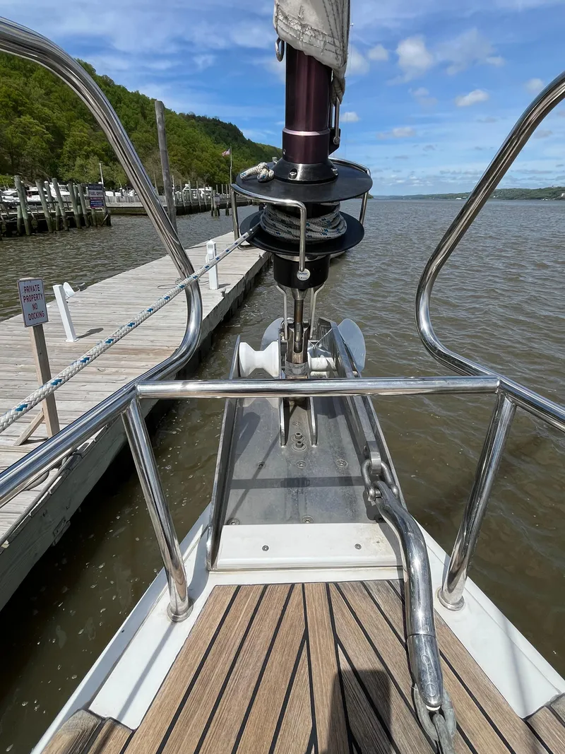 Slide: The Image of Bow of 2012 Beneteau Oceanis 58 sailboat docked by a wooden pier. - 30