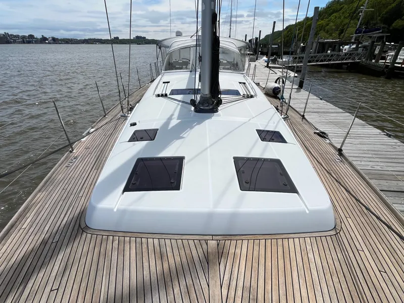 Slide: The Image of 2012 Beneteau Oceanis 58 sailboat docked, showcasing sleek deck design and spacious layout. - 33