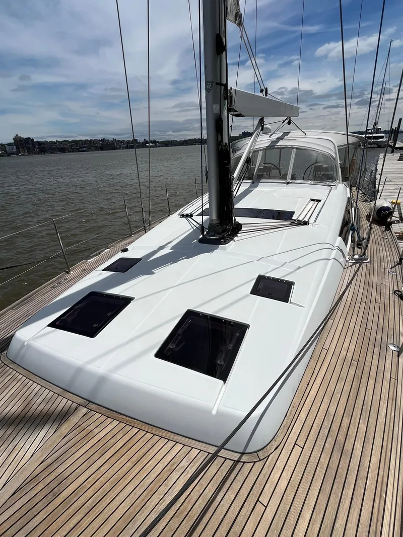Slide: The Image of 2012 Beneteau Oceanis 58 sailboat on deck, docked by the water. - 34