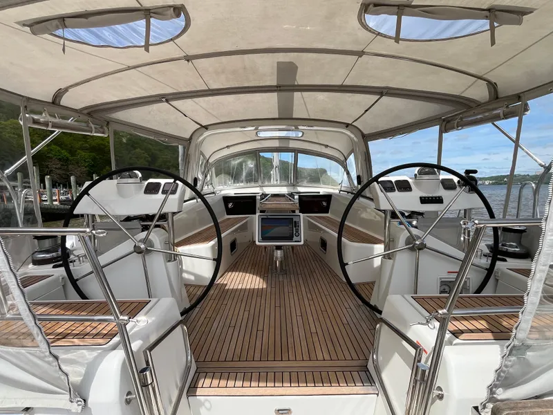 Slide: The Image of 2012 Beneteau Oceanis 58 yacht cockpit with dual steering wheels and teak flooring. - 4
