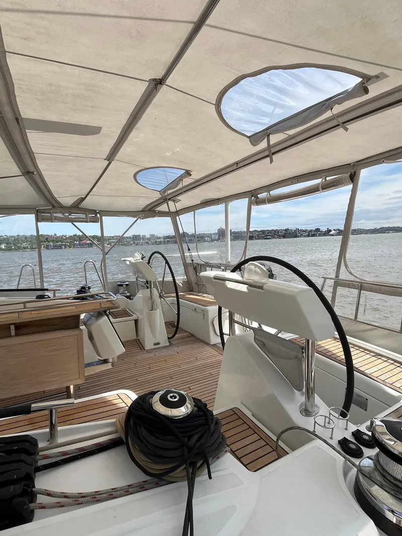 Slide: The Image of 2012 Beneteau Oceanis 58 yacht interior with dual steering wheels and spacious deck. - 42