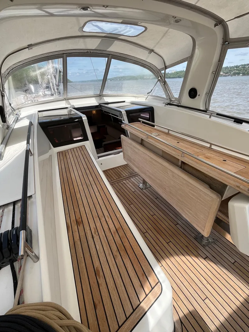 Slide: The Image of Spacious cockpit of 2012 Beneteau Oceanis 58 with wooden seating and panoramic views. - 43