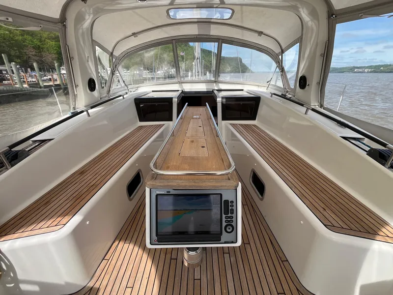 Slide: The Image of 2012 Beneteau Oceanis 58 cockpit with teak flooring and navigation display. - 46
