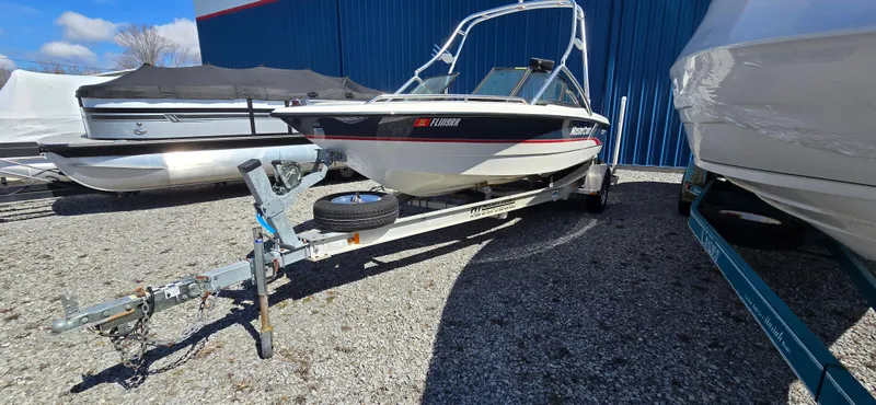 The Image of 1996 MasterCraft Prostar 205 boat on trailer, parked outdoors, sunny day. - 0