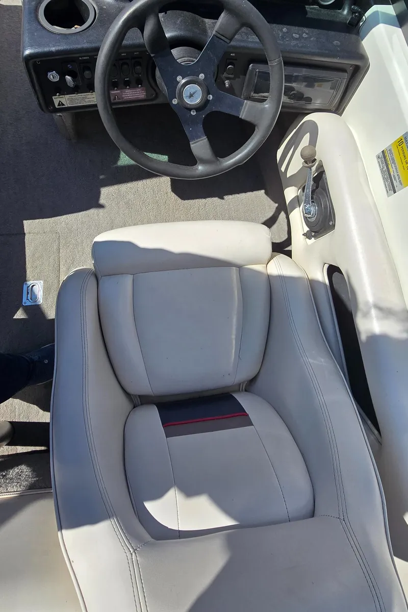 Slide: The Image of 1996 MasterCraft Prostar 205 boat interior with steering wheel and seat. - 21