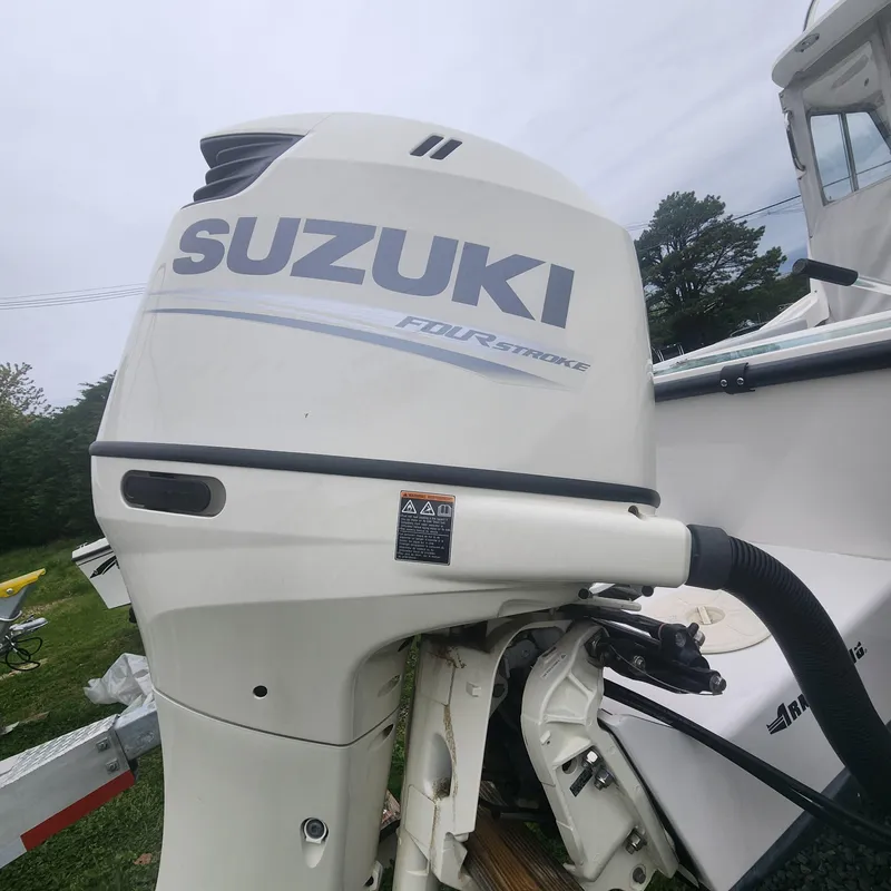 Slide: The Image of Suzuki outboard motor on a 2019 NorthCoast 215 Cabin boat. - 11