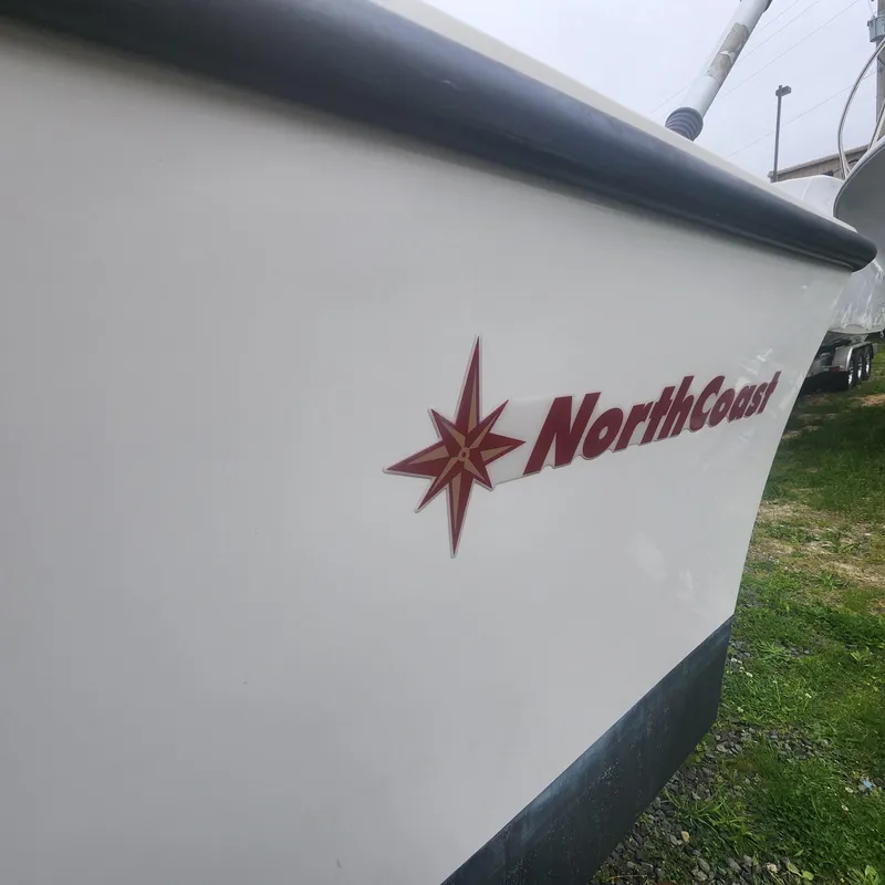 Slide: The Image of 2019 NorthCoast 215 Cabin boat side view with logo. - 13