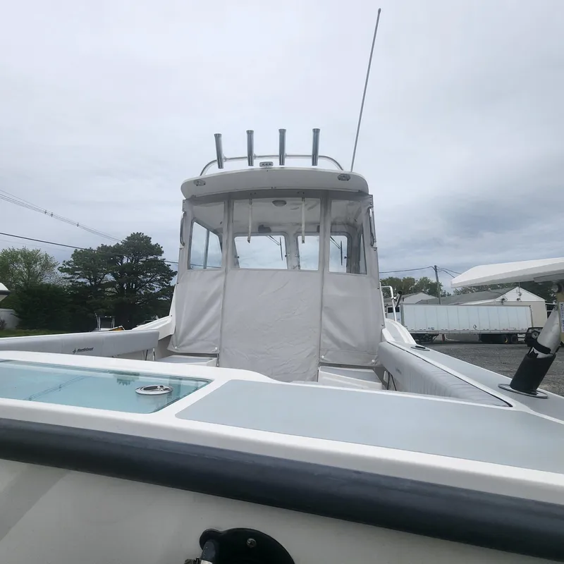 Slide: The Image of 2019 NorthCoast 215 Cabin boat with enclosed cockpit, docked outdoors. - 15