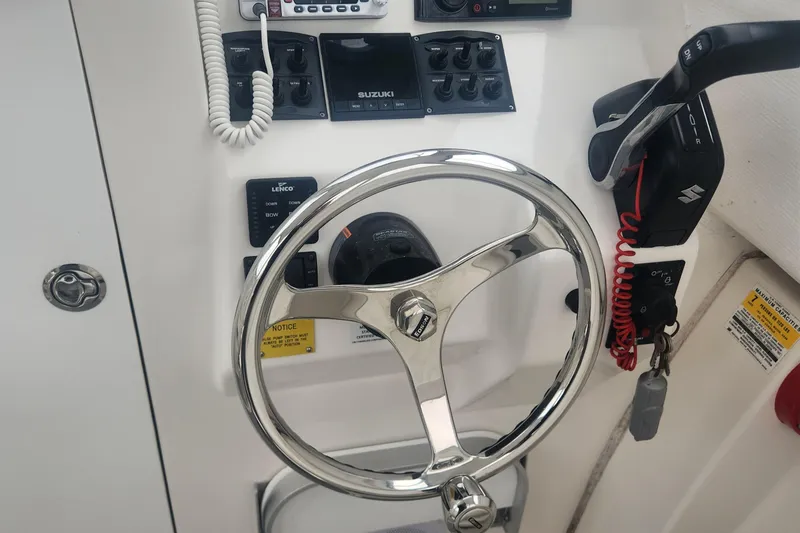 Slide: The Image of 2019 NorthCoast 215 Cabin boat helm with steering wheel and control panel. - 18