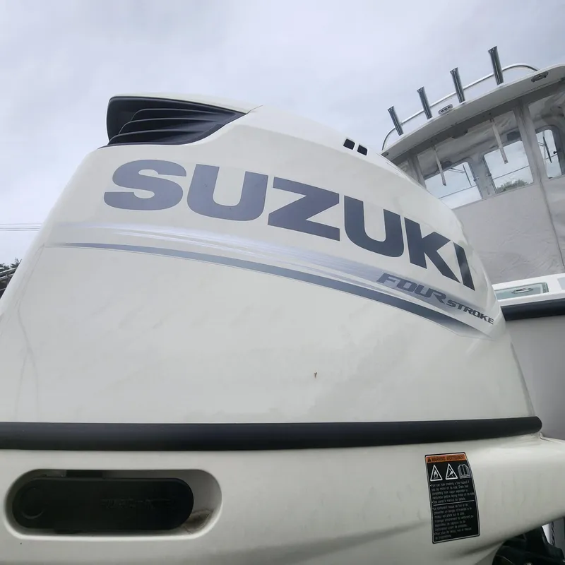 Slide: The Image of Close-up of Suzuki four-stroke outboard motor on 2019 NorthCoast 215 Cabin boat. - 9