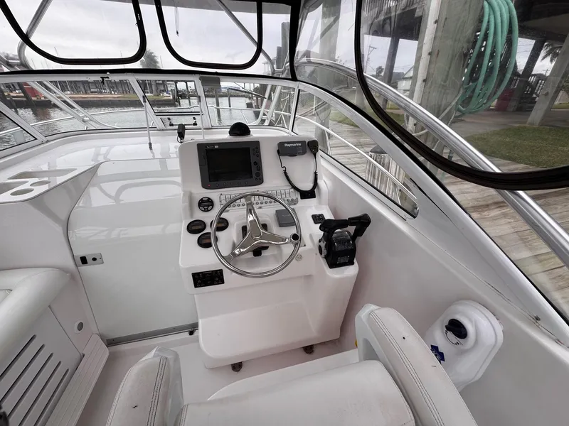 Slide: The Image of 2006 Pro-Line 32 Express boat helm with steering wheel and navigation equipment. - 10