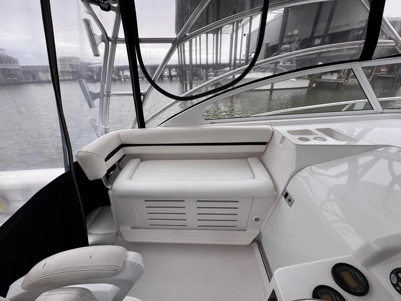 Slide: The Image of 2006 Pro-Line 32 Express boat interior with white seating and dashboard. - 12