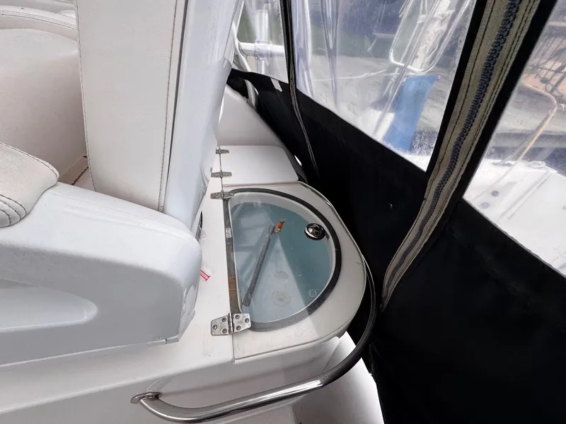 Slide: The Image of 2006 Pro-Line 32 Express boat interior with seating and circular hatch. - 13
