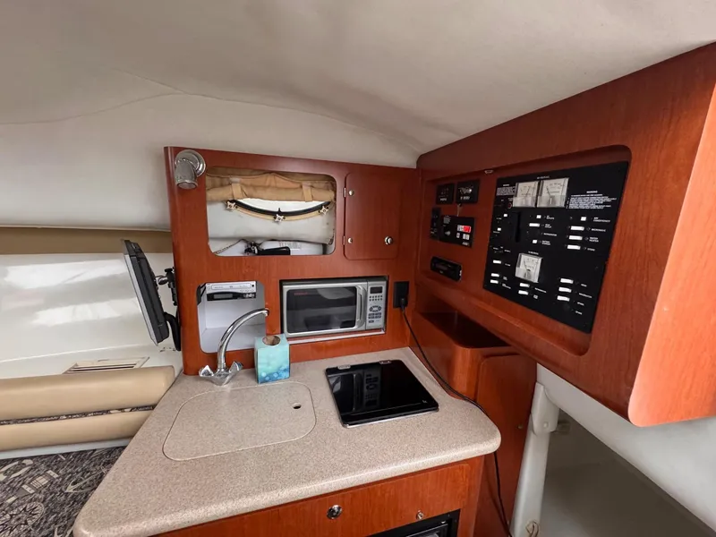 Slide: The Image of 2006 Pro-Line 32 Express cabin with kitchenette, microwave, and control panel. - 16