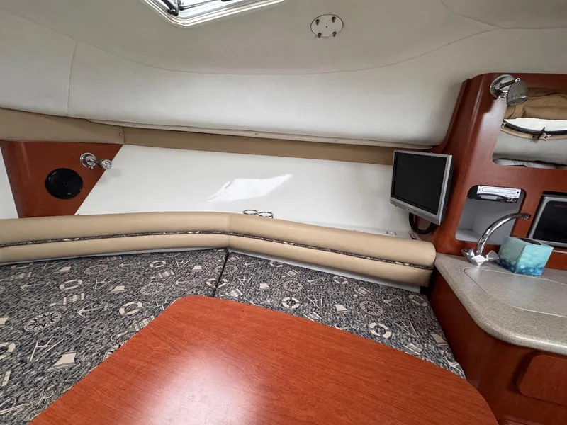 Slide: The Image of Interior of 2006 Pro-Line 32 Express boat with seating, table, and TV. - 18