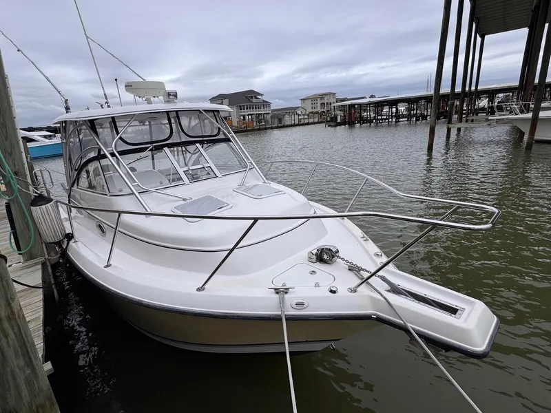 Slide: The Image of 2006 Pro-Line 32 Express boat docked in a marina. - 3