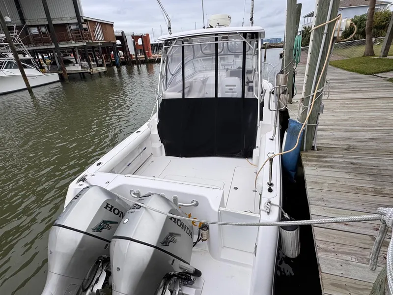 Slide: The Image of 2006 Pro-Line 32 Express boat docked with twin Honda outboard engines. - 4